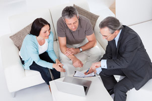 three people talking on couch