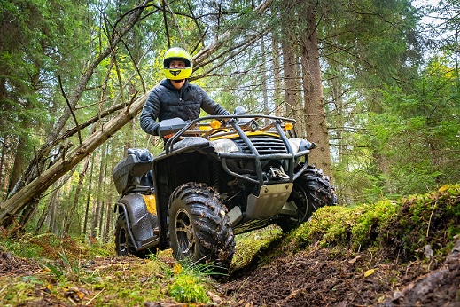 a man on a quadbike in the forest
