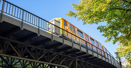 bottom to top view of an electric, yellow train