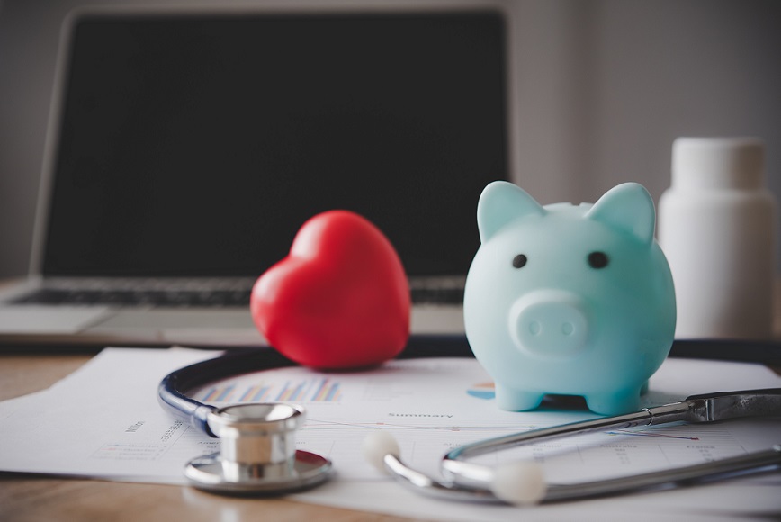 piggy bank on a table with stethoscope